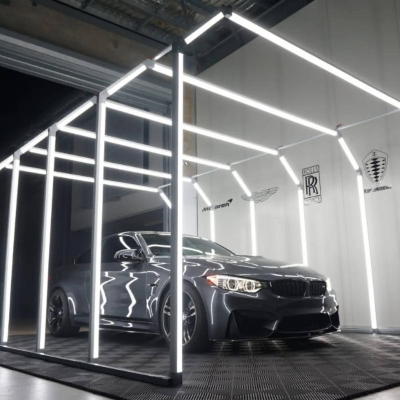 Black BMW inspected under a light tunnel during a Popz Detailing coating job